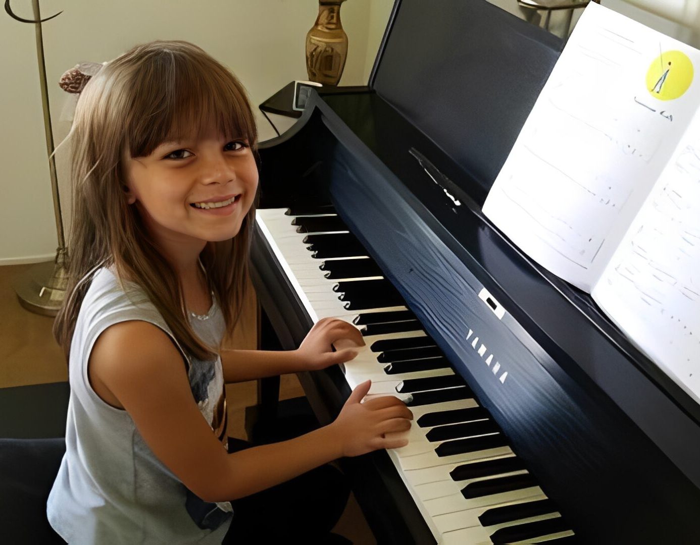 Young girl happily playing piano with sheet music.