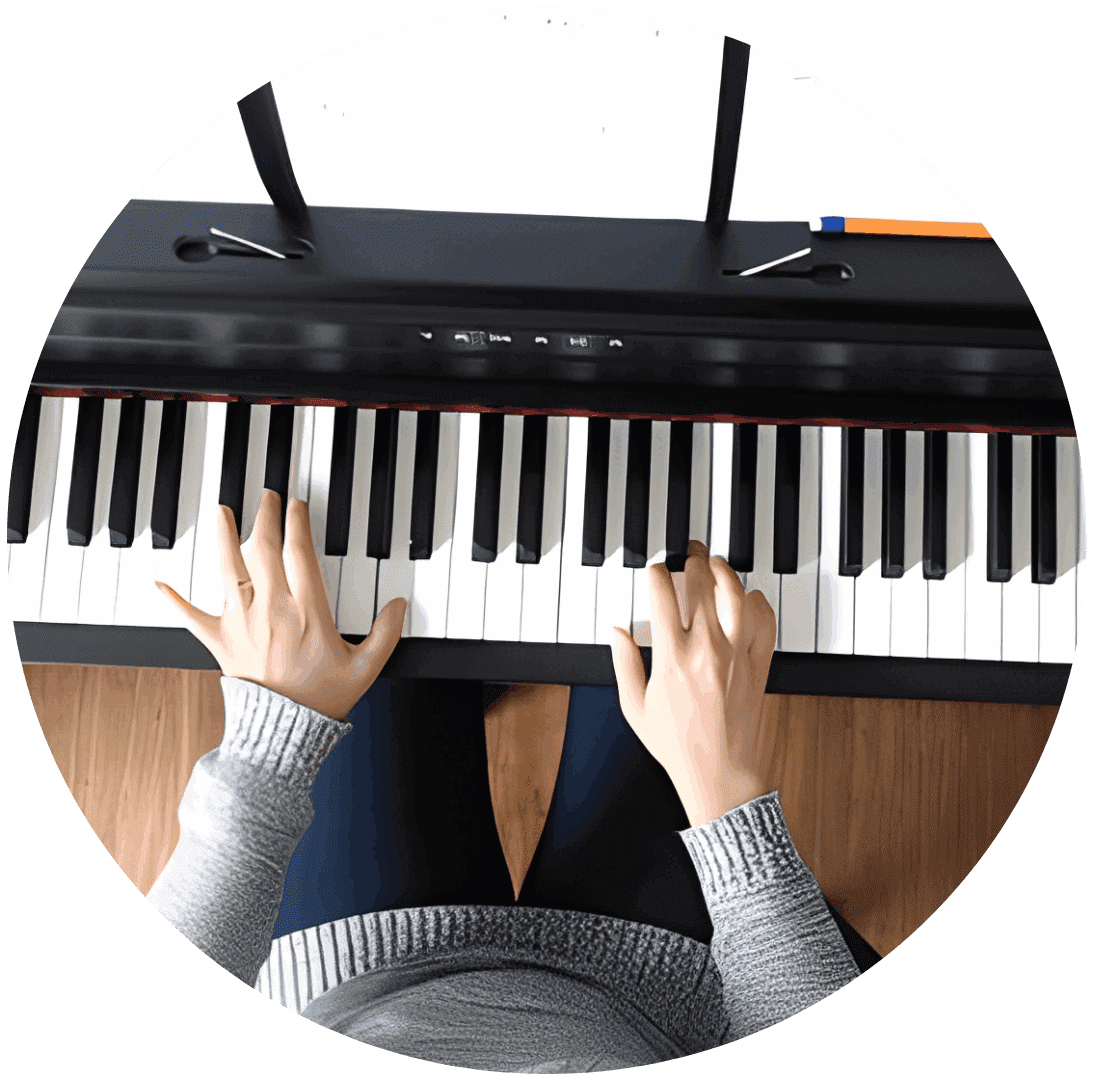 Hands playing a piano keyboard from above.