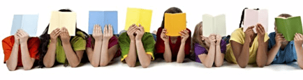 Children holding colorful books in front of their faces while lying on the floor.